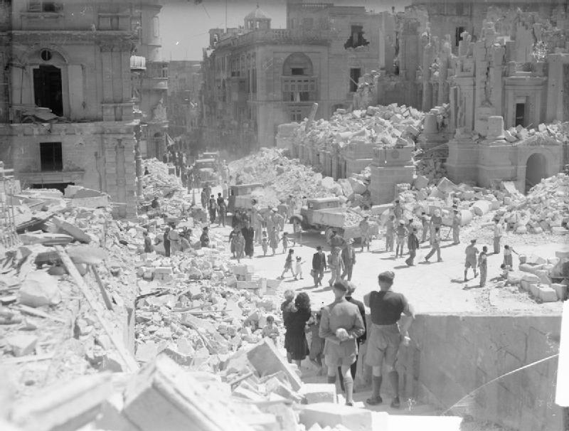 Servicemen and civilians clear bomb damage on Kingsway, Valletta, 1 May 1942, after the peak month of the Axis air offensive.