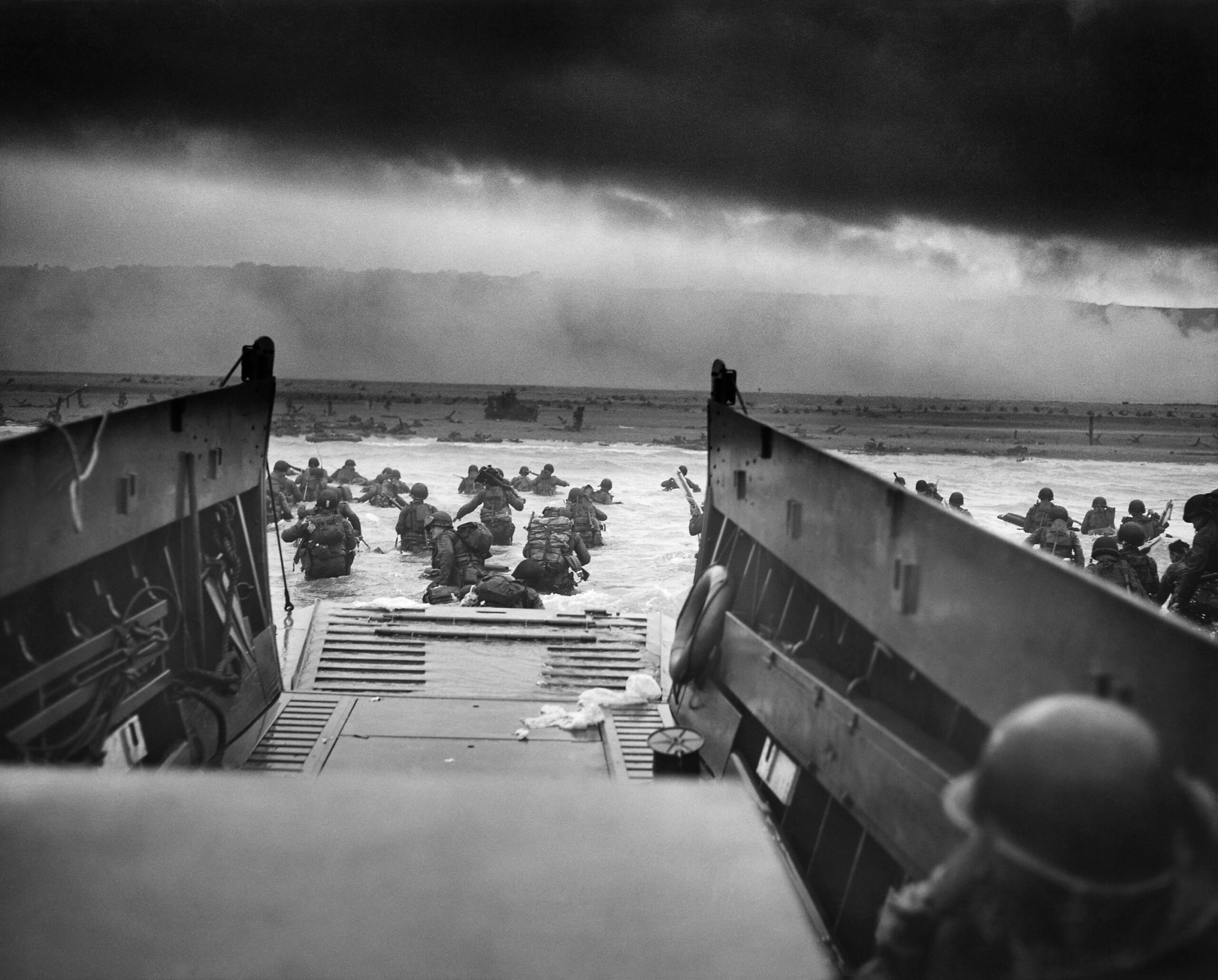 U.S. Army troops of the 16th Infantry Regiment wading ashore from a landing craft at Omaha Beach, Normandy, on 6 June 1944.